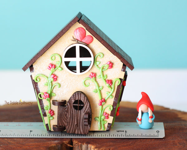 Tiny gnome home with itty bitty girl gnome - springtime miniature house with wildflowers