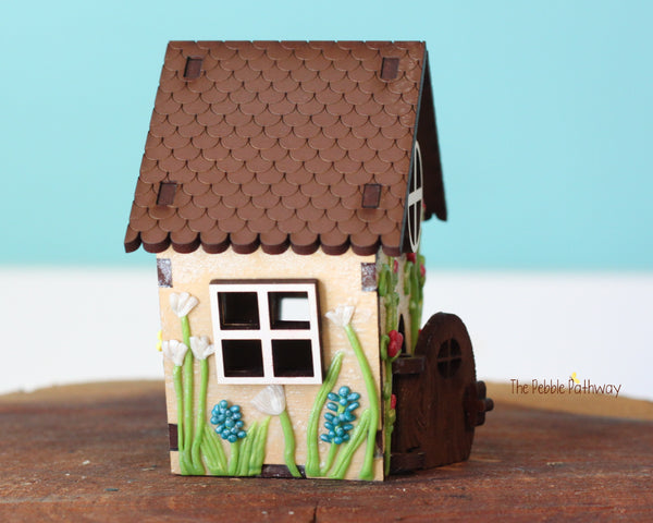 Tiny gnome home with itty bitty girl gnome - springtime miniature house with wildflowers