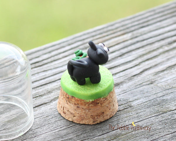 Black cat and tiny pumpkin in tiny cloche