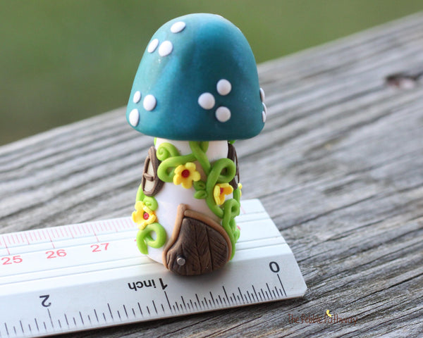 Tiny Blue mushroom gnome home with yellow flowers and vines