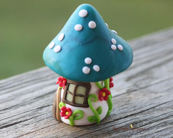 Tiny Blue mushroom gnome home with pink flowers and vines