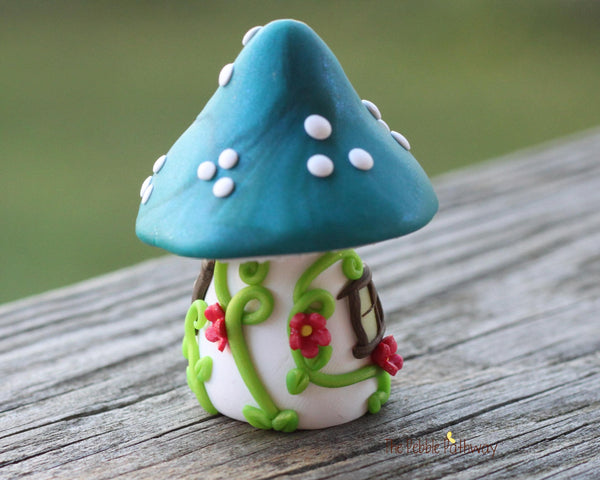 Tiny Blue mushroom gnome home with pink flowers and vines