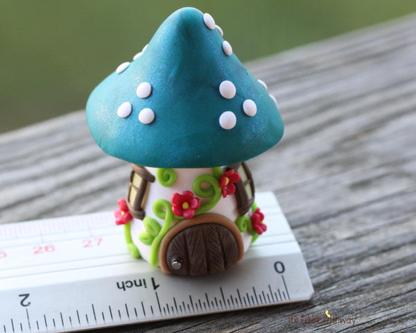 Tiny Blue mushroom gnome home with pink flowers and vines