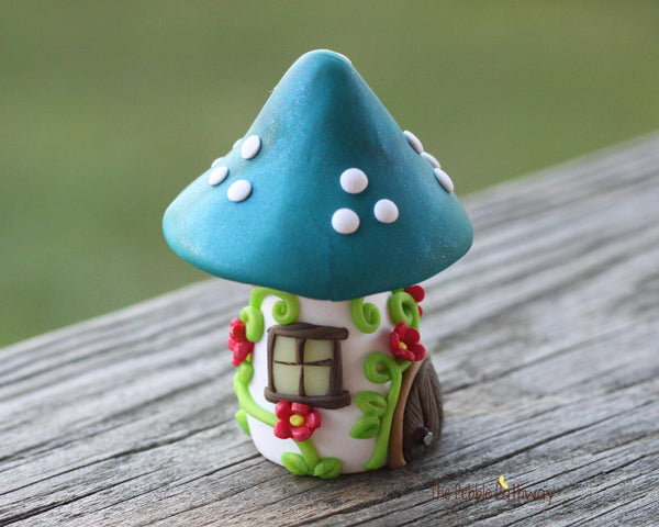 Tiny Blue mushroom gnome home with pink flowers and vines