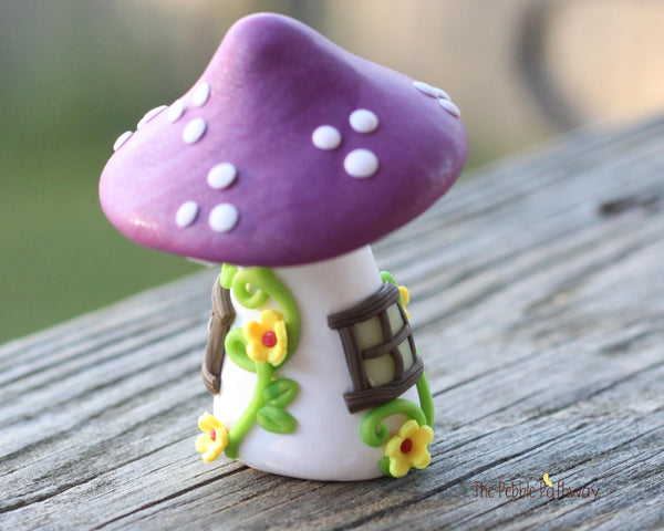 Tiny Purple mushroom gnome home with yellow flowers and vines