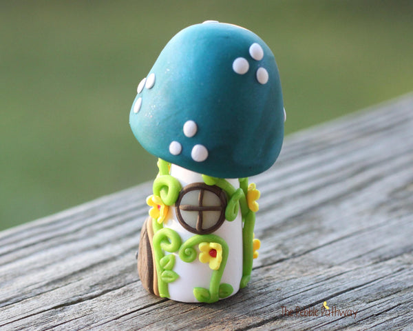 Tiny Blue mushroom gnome home with yellow flowers and vines