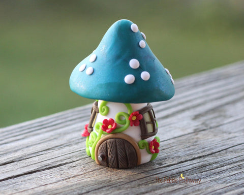 Tiny Blue mushroom gnome home with pink flowers and vines