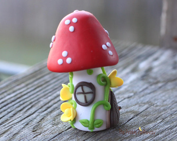 Tiny Red mushroom gnome home with yellow flowers and vines 2