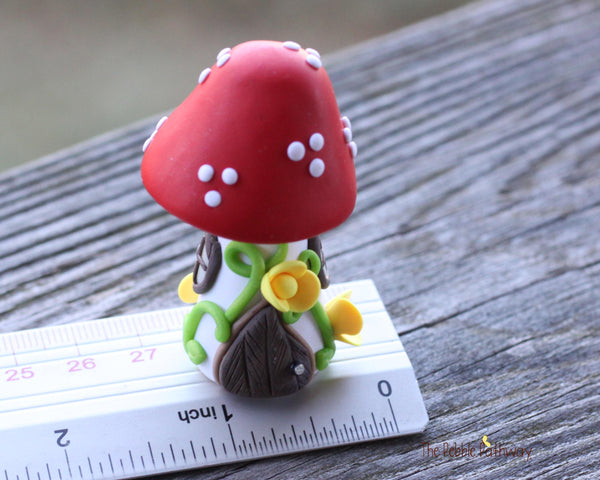 Tiny Red mushroom gnome home with yellow flowers and vines 2