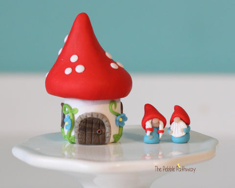 Tiny red mushroom with blue flowers gnome home with removable top and gnomes inside