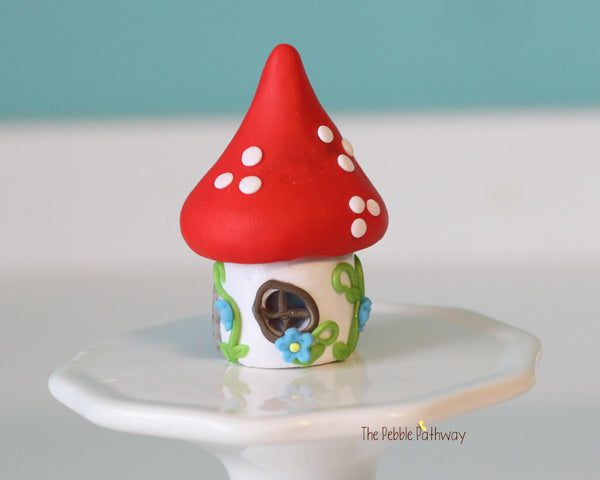 Tiny red mushroom with blue flowers gnome home with removable top and gnomes inside